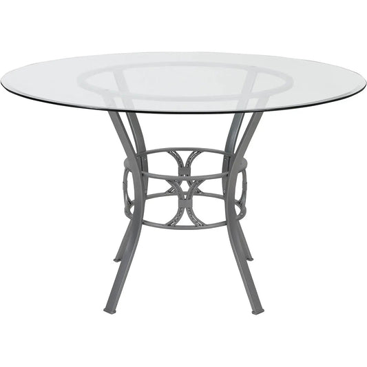 Round glass-top dining table with matte gray metal frame and curved decorative base on Tampa Home & Garden Store