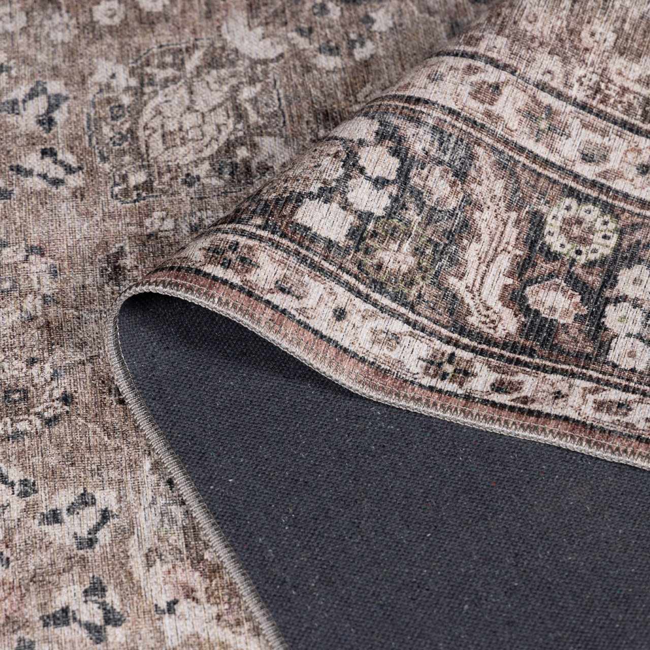 Ganyangan washable rug by Boutique Rugs, beige-brown vintage pattern with dark navy backing on Tampa Home & Garden Store
