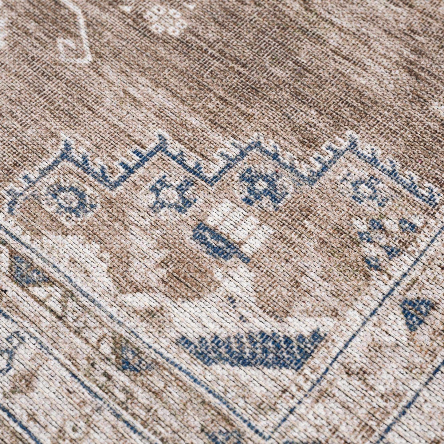 Baltinglass flat pile washable rug in beige-brown tones with blue border detail on Tampa Home & Garden Store
