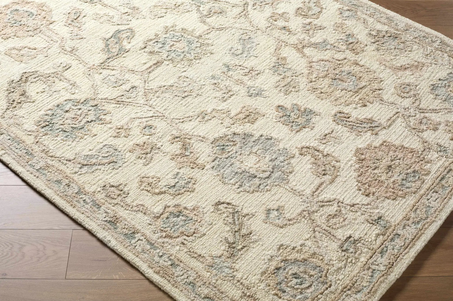 Callum Oushak wool area rug in ivory and sage with subtle floral motifs on Boutique Rugs on Tampa Home & Garden Store