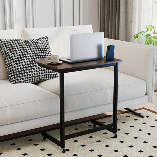 C-shaped end table with wheels, brown wood top and black frame beside sofa with laptop and phone on Tampa Home & Garden Store