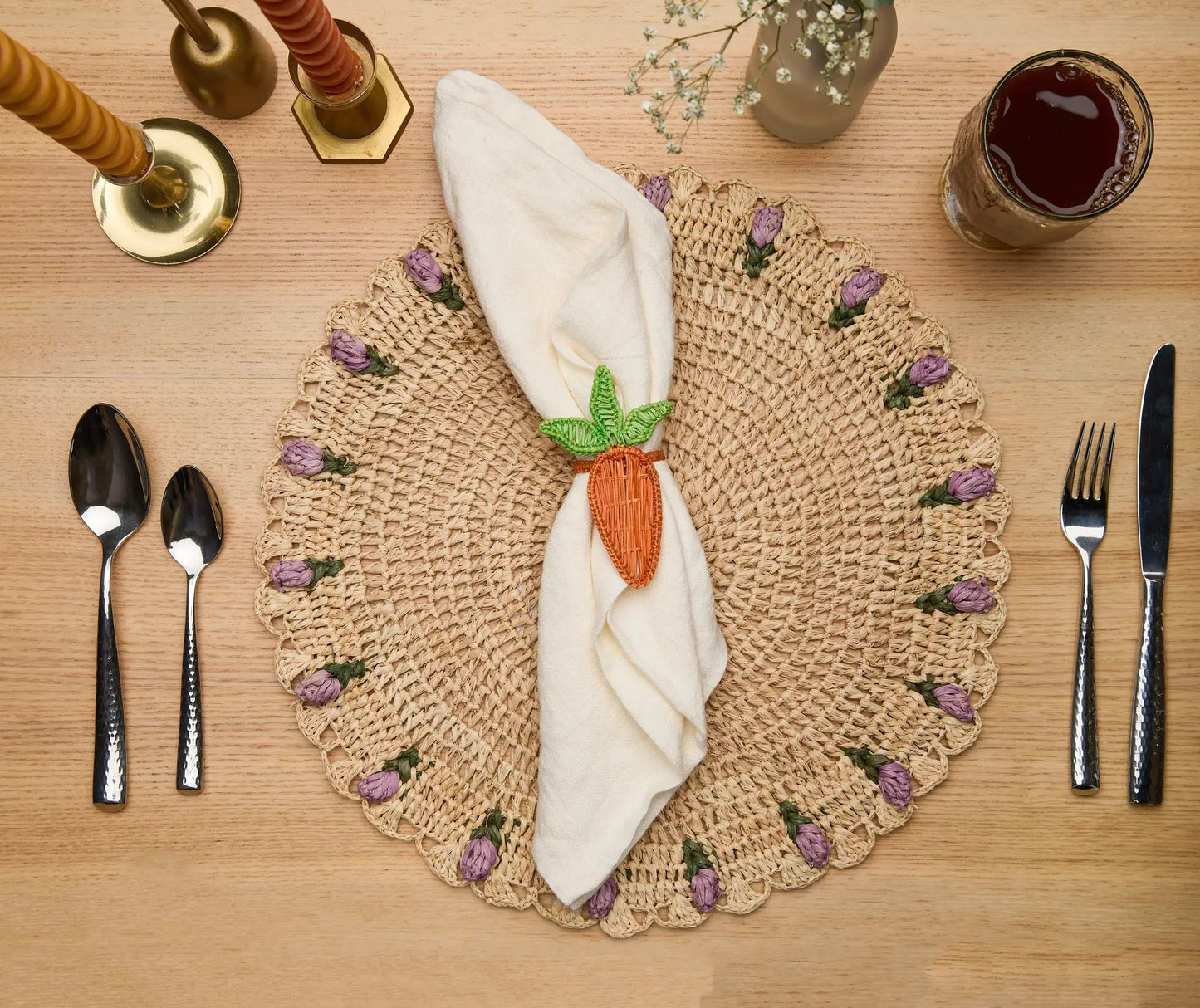Carrot Napkin Ring handwoven Iraca palm Colombia around white napkin on woven placemat on Tampa Home & Garden Store