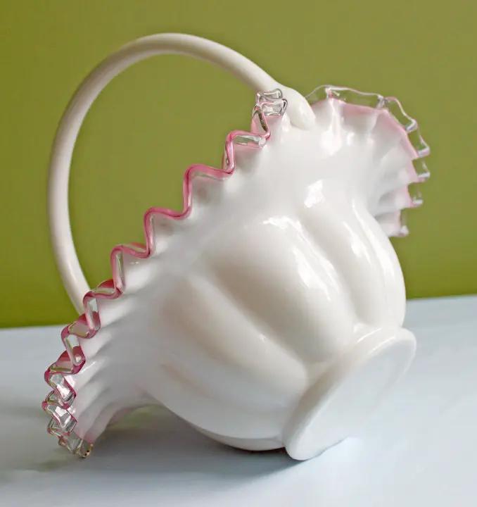 White ceramic egg basket with pink ruffled rim and curved handle on Tampa Home & Garden Store