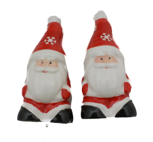 Pair of ceramic Santa salt and pepper shakers with red hats, snowflakes, beards, black boots on Tampa Home & Garden Store