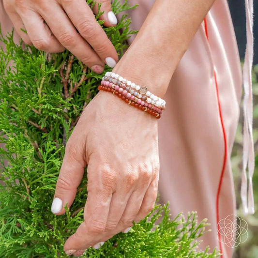 Change and Transformation Bracelet Pack of Four pink and white bead bracelets on wrist on Tampa Home & Garden Store