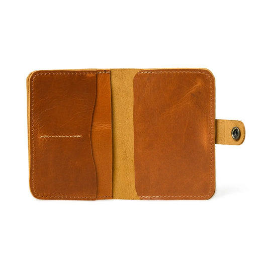 Chic Voyage tan brown leather passport sleeve with slim center strap and neat stitching on Tampa Home & Garden Store