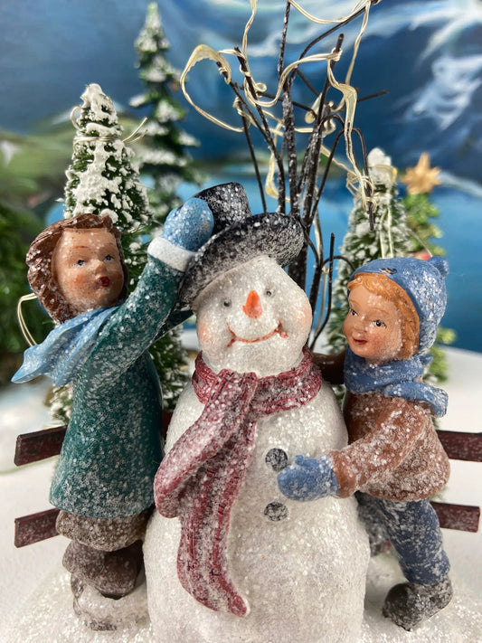Two Christmas Trees and Little Girl Figurine Set with frosted trees and blue winter wear on Tampa Home & Garden Store