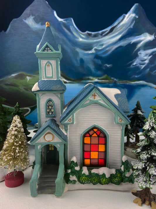 Cedar Valley Chapel blue church from Christmas set with stained-glass window and snow on Tampa Home & Garden Store
