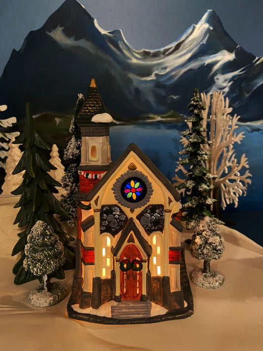 Christmas Village Church with Stained Glass, snow-covered roof, warm-lit windows on Tampa Home & Garden Store