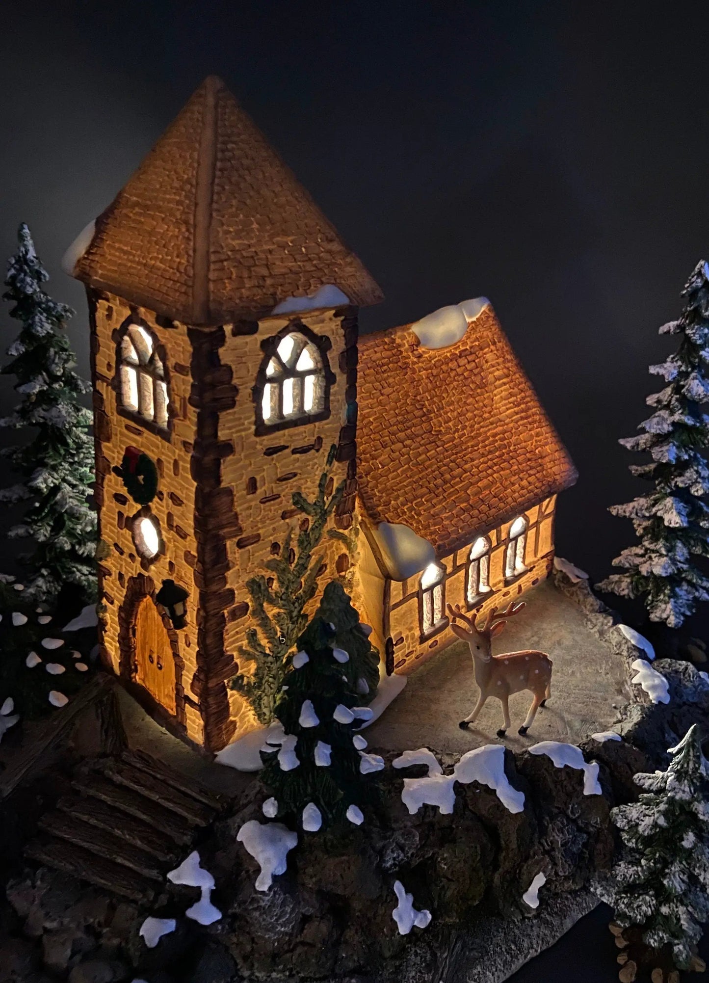 Christmas Village Church with Stained Glass; brick tower, snow roof, lit windows, deer nearby on Tampa Home & Garden Store