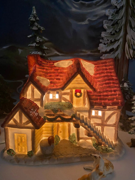 Porcelain Christmas Village Farm House with red roof, warm-lit windows and wreath on Tampa Home & Garden Store