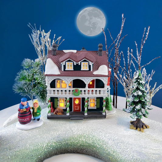 Captain's Cottage Christmas Village House 56, snowy two-story with lit windows and porch on Tampa Home & Garden Store