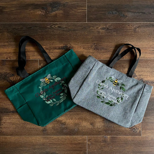 Claire's Apothecary embroidered tote bags teal and gray pair with bee botanical embroidery on Tampa Home & Garden Store