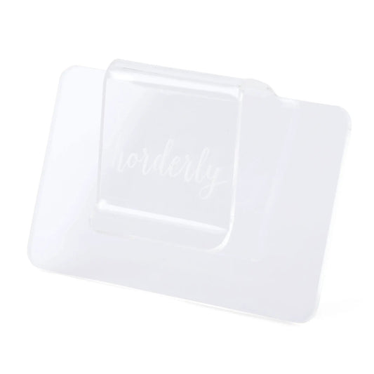 Clear acrylic bin clip label holder on a white storage bin for organization on Tampa Home & Garden Store
