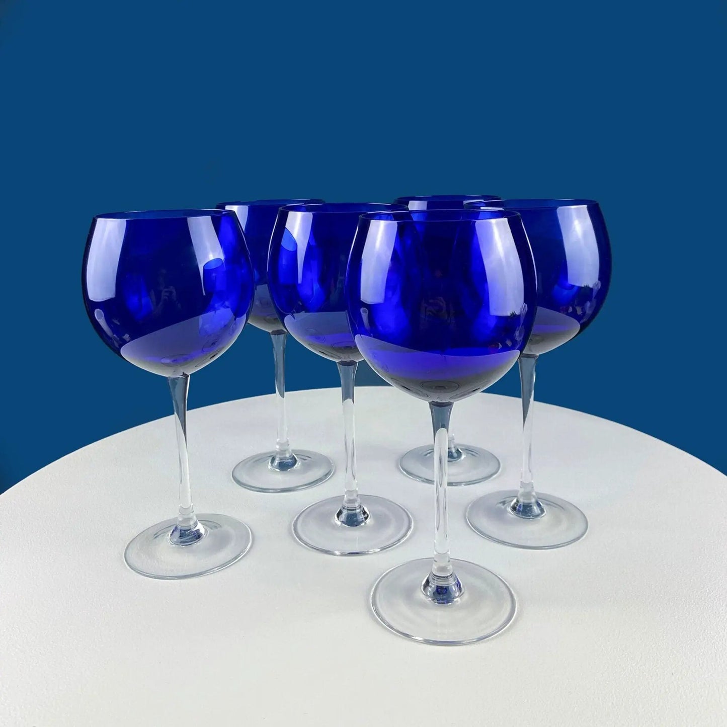 Cobalt blue stemware wine glasses set of four with slender clear stems on white surface on Tampa Home & Garden Store