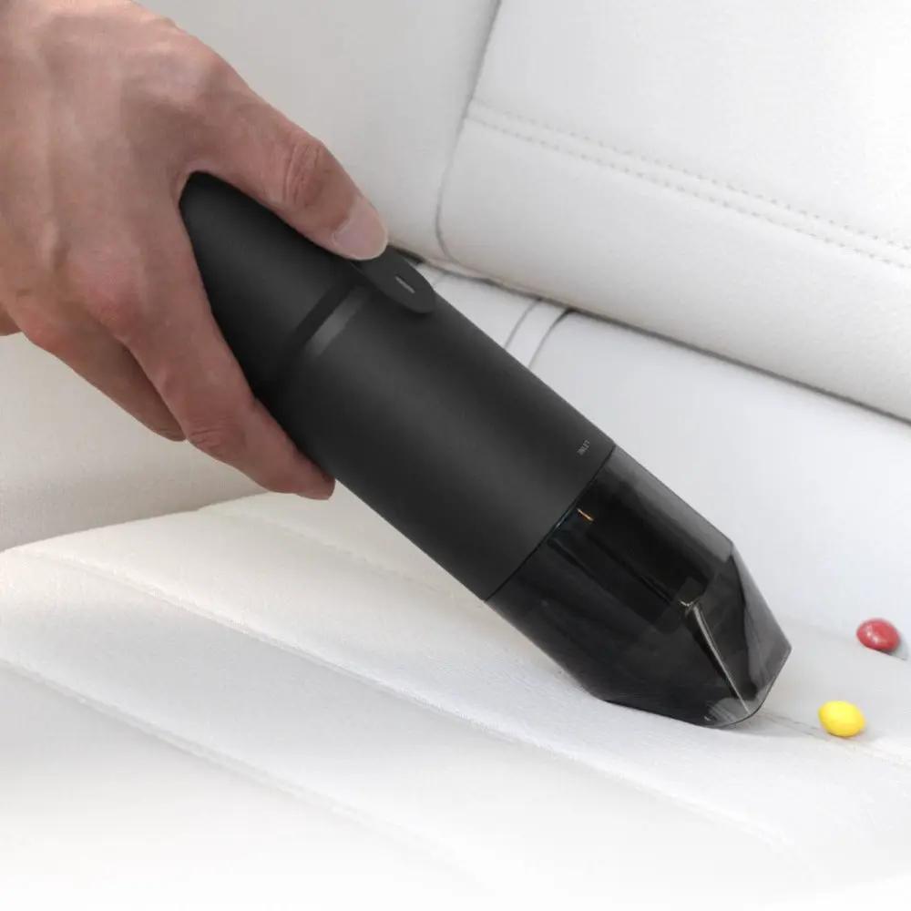 HOTO Compressed Air Capsule Vacuum 4 In 1 handheld black nozzle on white couch on Tampa Home & Garden Store