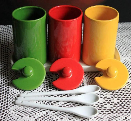 Condiment jars with lids and tray spoons, three colorful jars green red yellow on a white tray on Tampa Home & Garden Store