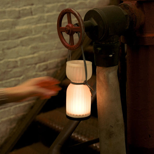 Cordless Camp Lantern USB-C Rechargeable Light hanging from a red valve wheel on an industrial pipe on Tampa Home & Garden Store