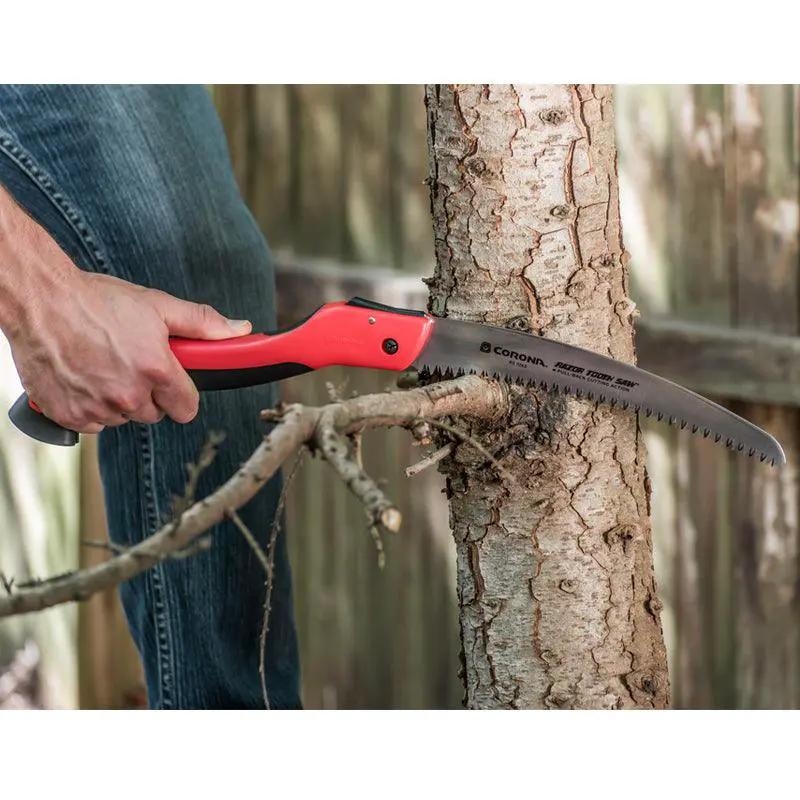 Corona 7in folding Razor Tooth pruning saw with red handle cutting a tree branch on Tampa Home & Garden Store