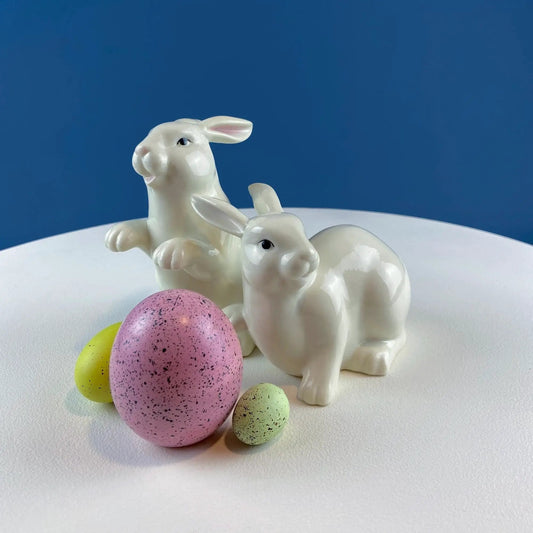 Two white porcelain bunny figurines with pastel speckled eggs, Easter decor on Tampa Home & Garden Store