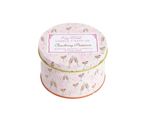 Cranberry Prosecco Travel Tin Candle by Key West Candle & Bath Co., pink tin with champagne flute pattern on Tampa Home & Garden Store