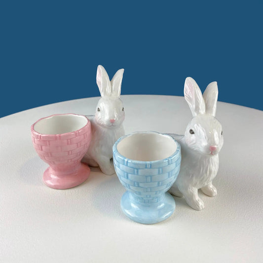 Bunny egg cups set of two in pastel pink and blue with white bunny figurines on Tampa Home & Garden Store