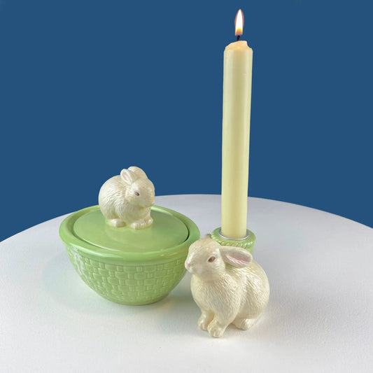 Cute Bunny Candle Holder with white bunnies in a lime basket and ivory candle on a blue backdrop on Tampa Home & Garden Store