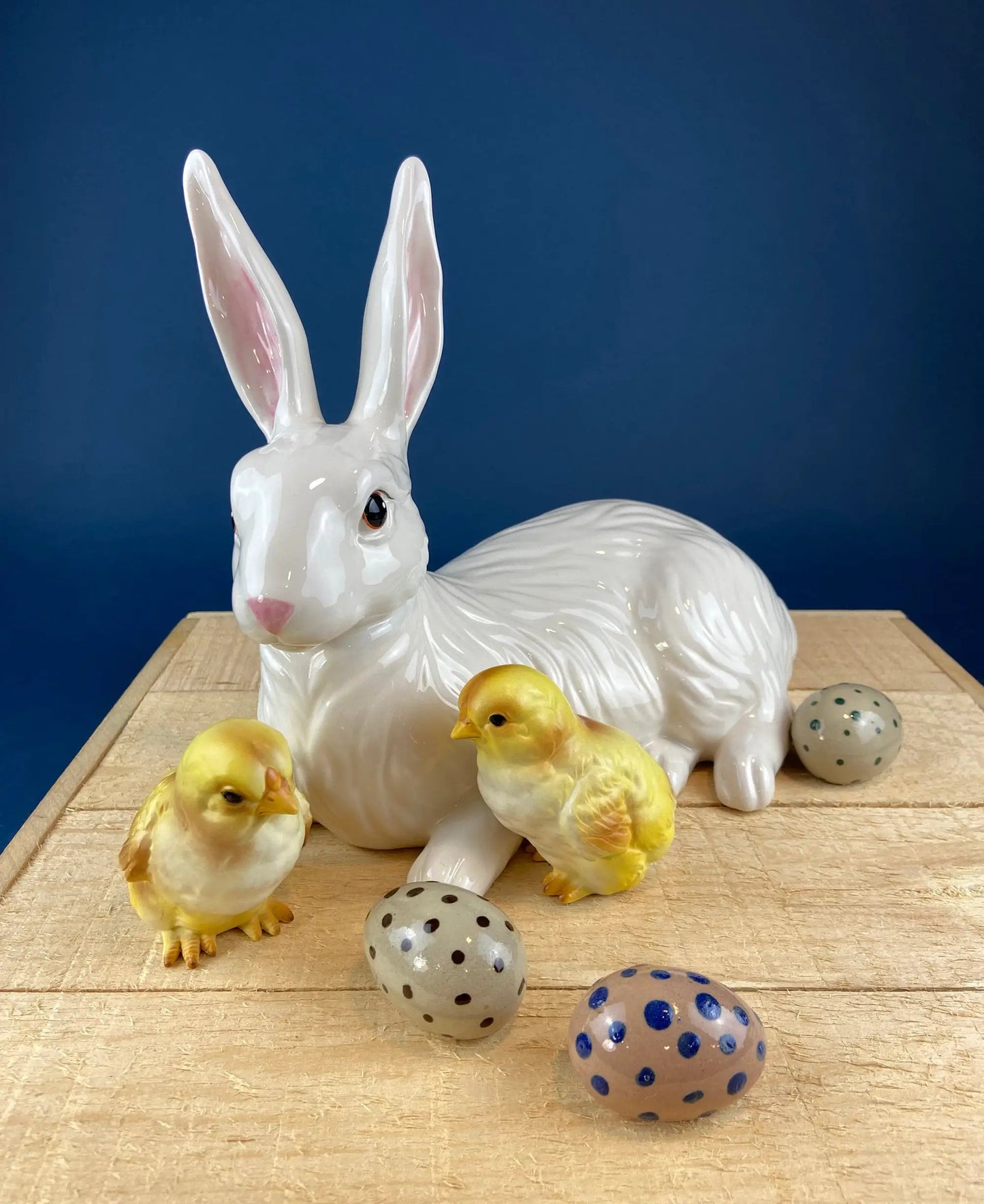 Yellow baby chick figurines with a white ceramic bunny and speckled eggs on a wooden table on Tampa Home & Garden Store