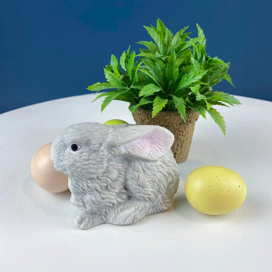 Porcelain gray bunny figurine with pink ears and textured fur beside a plant and eggs on Tampa Home & Garden Store