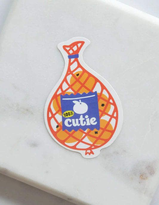 Die-cut sticker of Cutie Mandarins in an orange lattice bag with a blue label for notebooks on Tampa Home & Garden Store