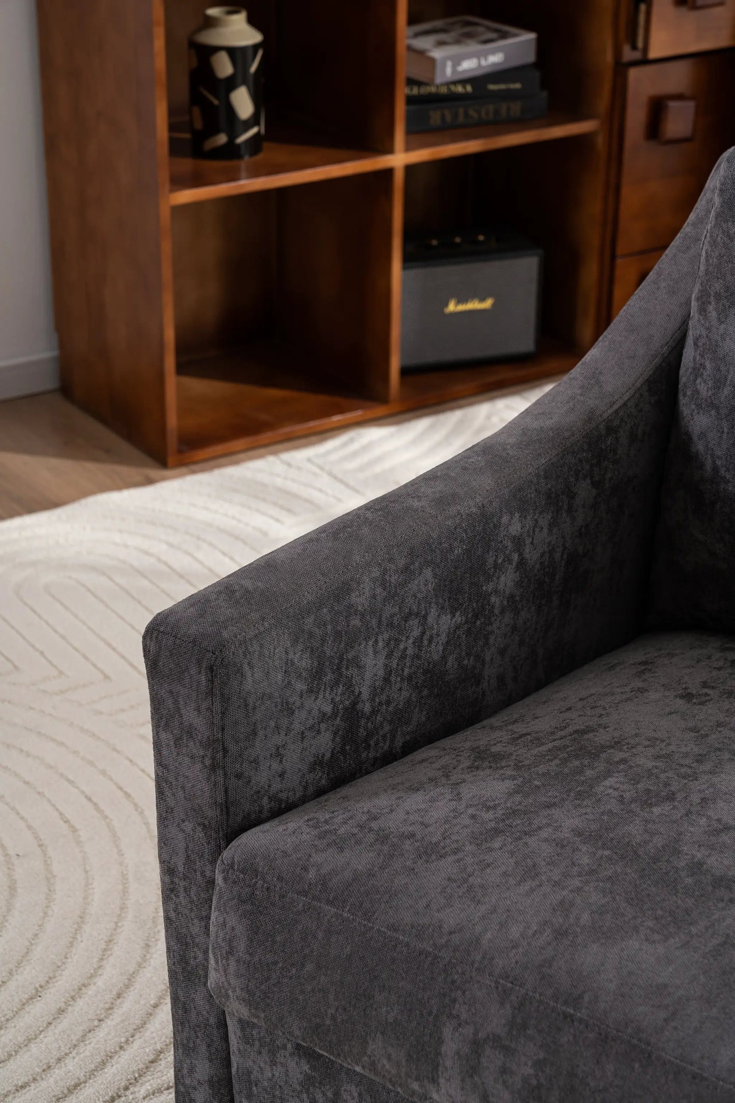 Large swivel chair in gray linen with soft cushions; wood shelf with mug and Marshall speaker in background on Tampa Home & Garden Store