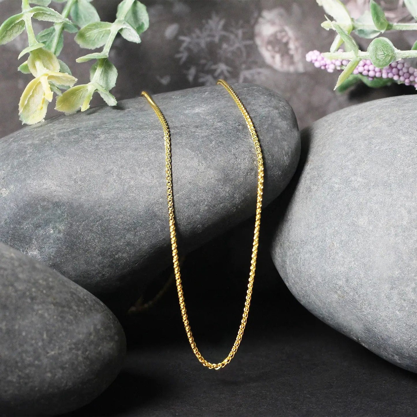 14k yellow gold diamond-cut round wheat chain necklace 1.1mm, two strands draped on gray stones on Tampa Home & Garden Store