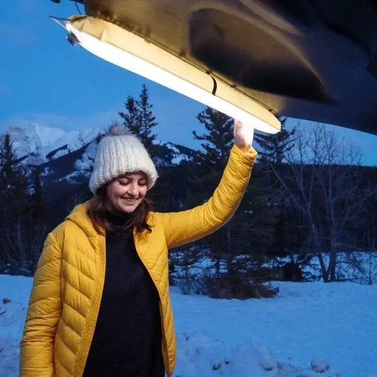 Outdoor Inflatable Solar Camping Lantern USB with bright white LED outdoors in snow on Tampa Home & Garden Store