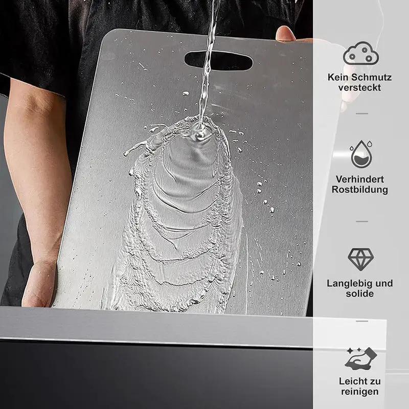Medical Grade Titanium double-sided cutting board in silver with top carry handle on Tampa Home & Garden Store