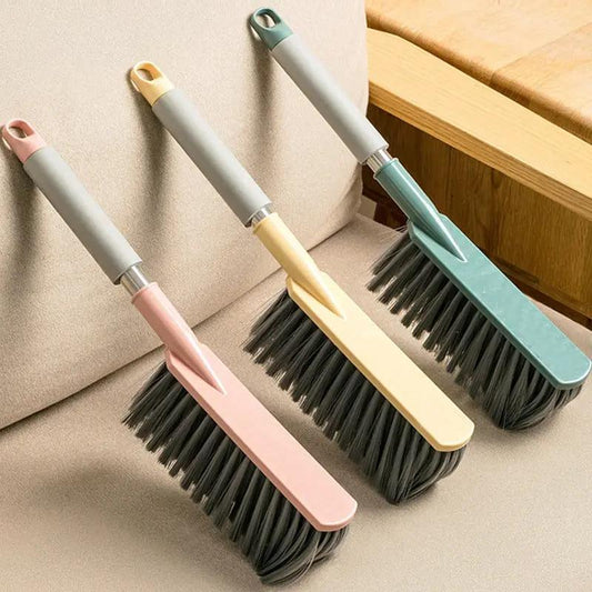 Three long-handle bed brushes with pastel pink, yellow, green gray grips and black bristles on Tampa Home & Garden Store