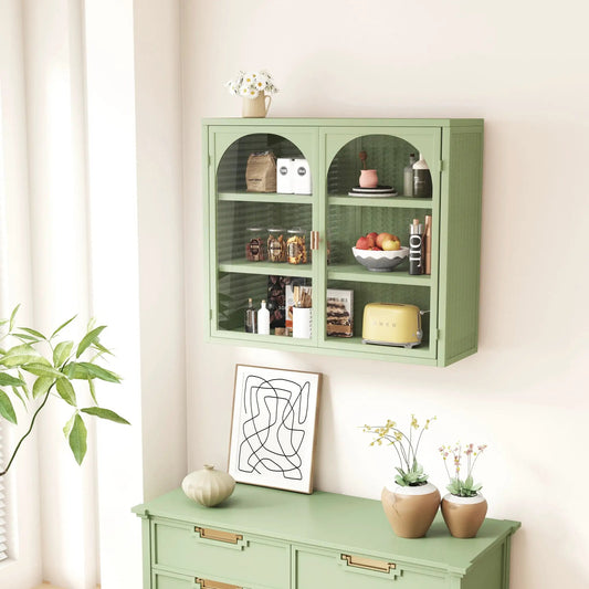 Mint green glass-front wall cabinet with three tiers and arched doors topped by a daisy vase on Tampa Home & Garden Store