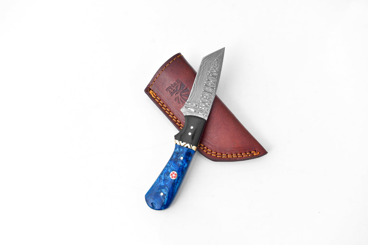 Midnight Fury Damascus Tanto Knife with blue marbled handle and Damascus blade beside sheath on Tampa Home & Garden Store