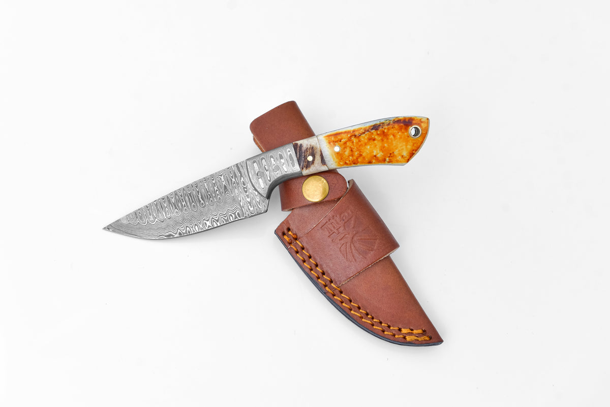 Titan Scorched Timber Damascus EDC Knife with orange handle in leather sheath on Tampa Home & Garden Store