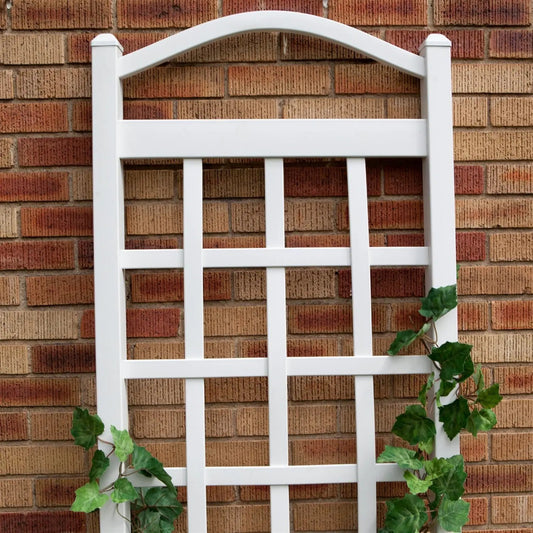 6 ft white vinyl garden trellis with arch top against brick wall with ivy on Tampa Home & Garden Store