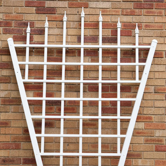 7.75 ft fan-shaped garden trellis in white vinyl leaning against a brick wall on Tampa Home & Garden Store