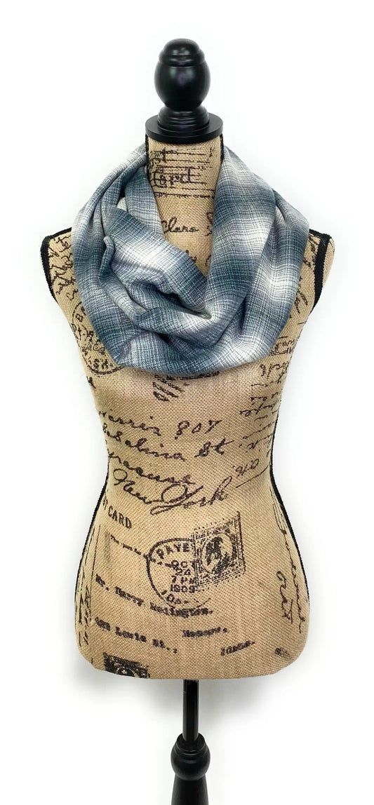 Dark blue ombre plaid flannel blanket scarf wrapped around a mannequin bust on Tampa Home & Garden Store