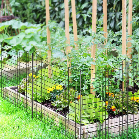 Decorative garden fence with five black wire panels and wooden stakes around a raised bed on Tampa Home & Garden Store