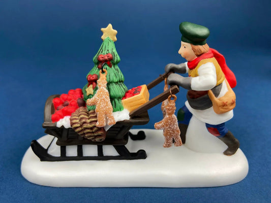Dickens Village Gingerbread Vendor with Kids figurine on a cart of treats and a tree on Tampa Home & Garden Store