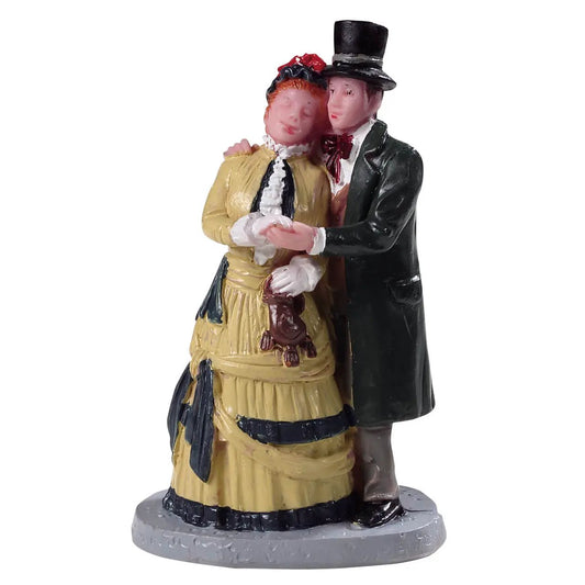 Dickens Couple Figurine for Christmas Village embracing couple in yellow gown and black coat on Tampa Home & Garden Store