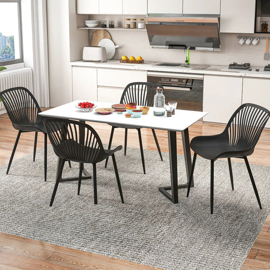 6 black metal-legged dining chairs with spindle backs around a table in a modern kitchen on Tampa Home & Garden Store