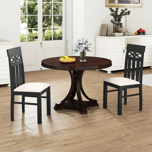 Dining chairs set of 2: black high-back with cream padded seats around round dark wood table on Tampa Home & Garden Store