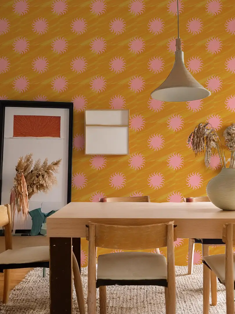 Sol Wallpaper yellow and light pink sunburst motif on wall with dining table and vase on Tampa Home & Garden Store