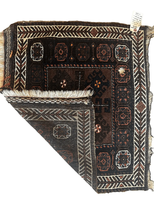 Hand-knotted Afghan Baluchi wool rug with dark brown field and ivory rust geometric borders on Tampa Home & Garden Store