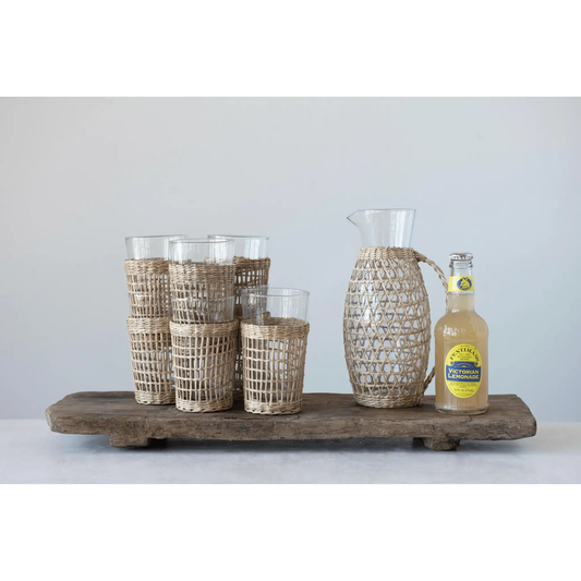 Drinking glasses with woven seagrass sleeves, White Cliff Studio tumblers in wicker baskets on Tampa Home & Garden Store