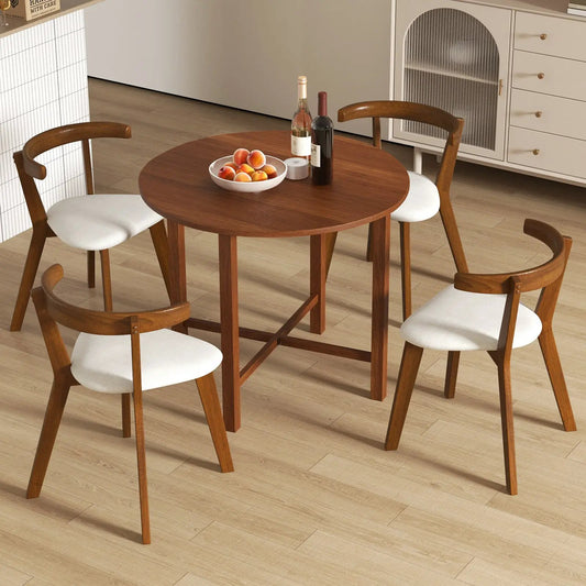 Walnut dual drop-leaf round dining table with four wood chairs in small-space kitchen on Tampa Home & Garden Store